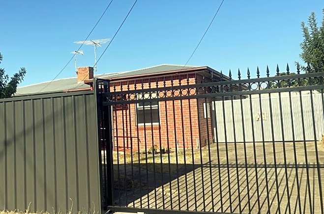 The street frontage of the home, with a secure gated driveway